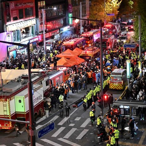 Crowds are seen around the area, where dozens of people suffered cardiac arrest, in the popular nightlife district of Itaewon in Seoul on October 30, 2022. - Dozens of people suffered from cardiac arrest in the South Korean capital Seoul, after thousands of people crowded into narrow streets in the citys Itaewon neighbourhood to celebrate Halloween, local officials said. (Photo by Jung Yeon-je / AFP) (Photo by JUNG YEON-JE/AFP via Getty Images)